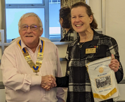 Peter Watson, President of Dunmow Rotary Club, presenting Pip Heath with a Dunmow Rotary pennant.